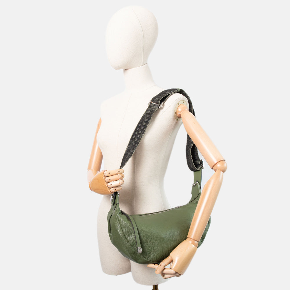 green pebbled leather sling bag with webbing crossbody strap