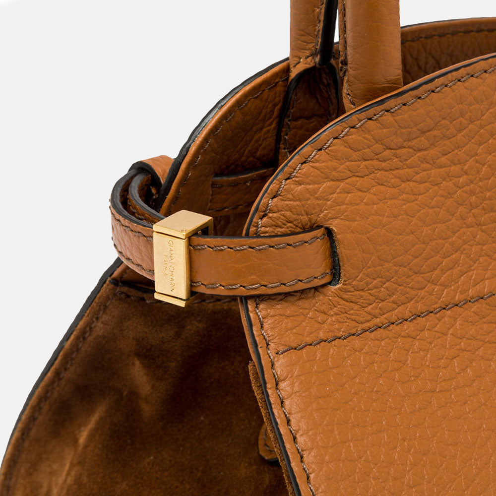 brown leather pebbled leather handbag with tonal suede side panels and top grab handles