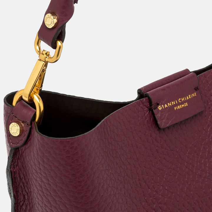 burgundy pebbled leather handbag with grab handle and gold hardware