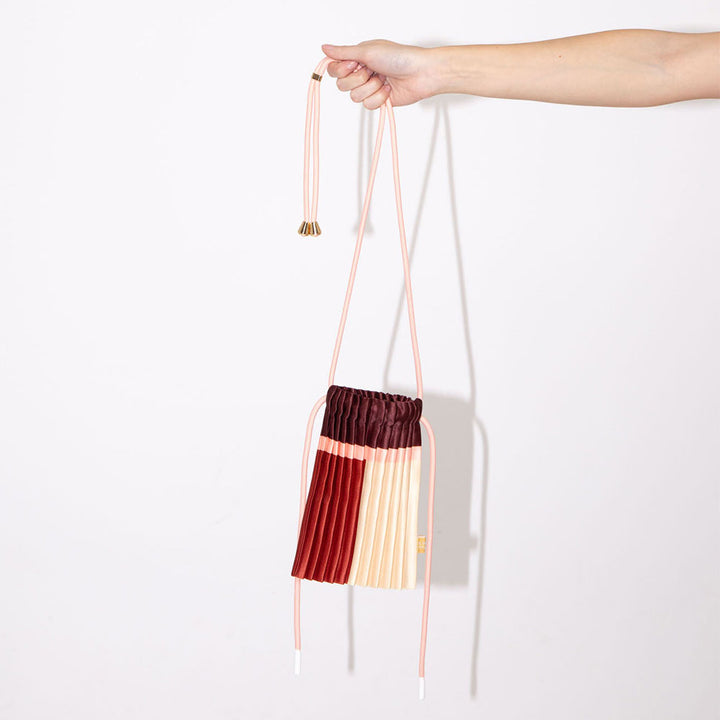 satin pleated mini crossbody bag in red, burgundy, cream & pink with cord adjustable strap