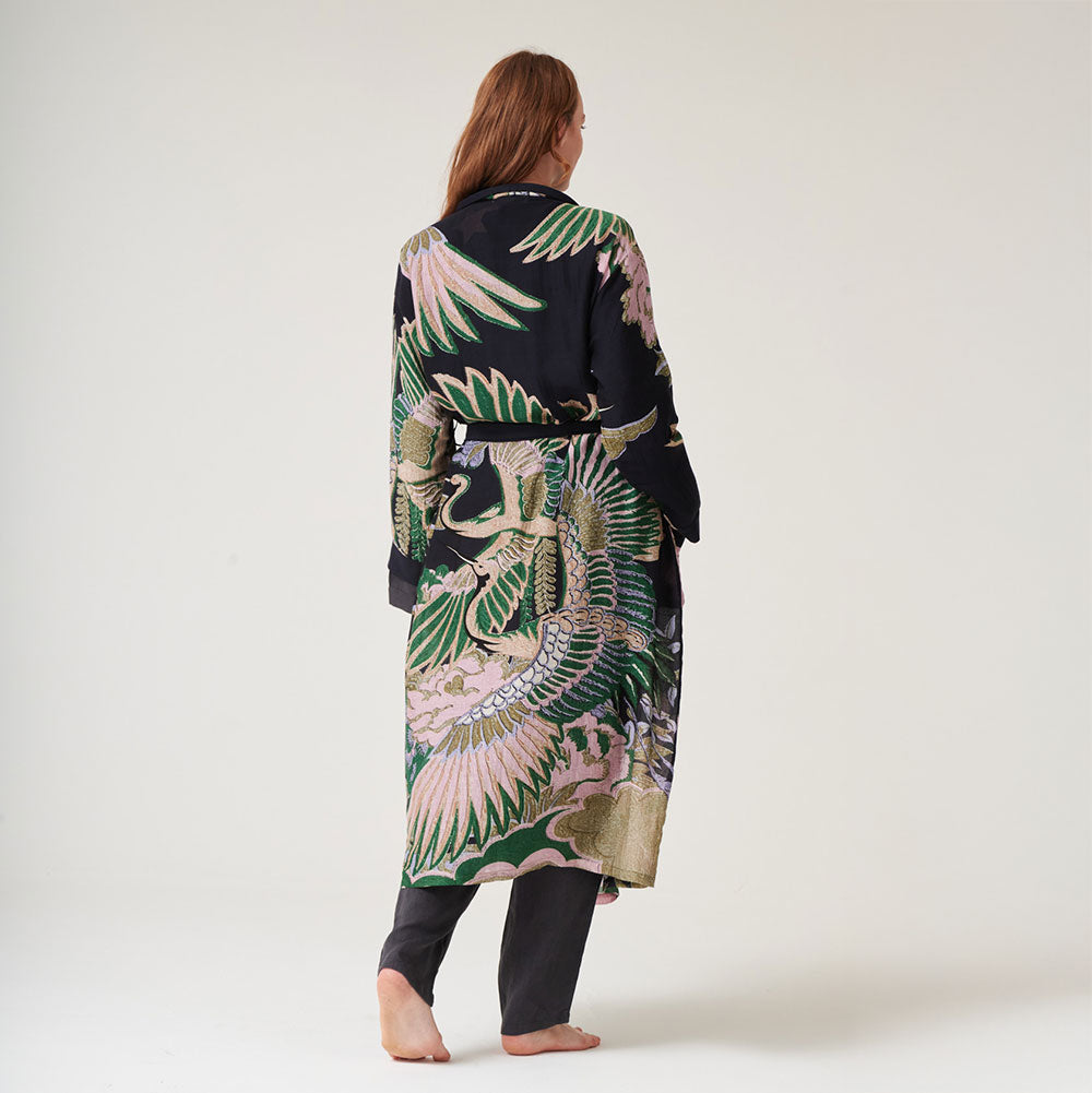 women's dressing gown in black featuring a design of cranes in sand, pink & green, worn with lounge pants 