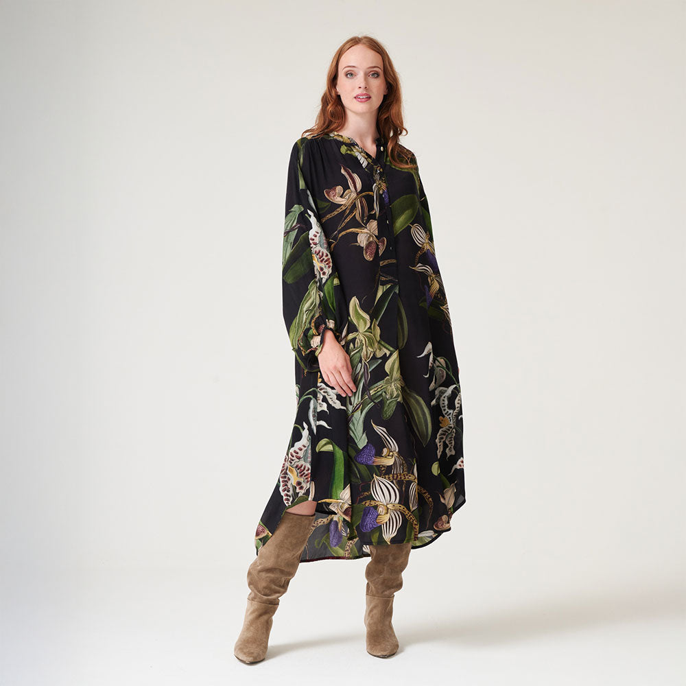 mid length dress mandarin collar dress in matt black with orchid print in green, blue & ivory, worn with brown suede boots