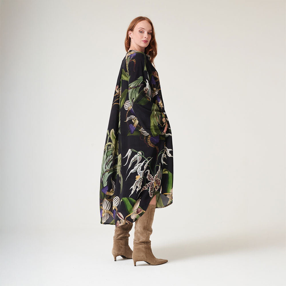 mid length dress mandarin collar dress in matt black with orchid print in green, blue & ivory, worn with brown suede boots