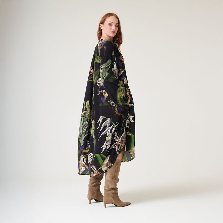 mid length dress mandarin collar dress in matt black with orchid print in green, blue & ivory, worn with brown suede boots