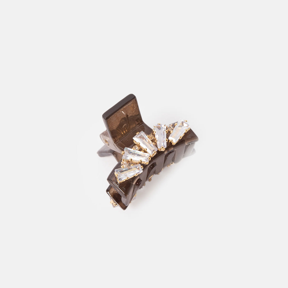 Jewelry clip with crystal details on a light gray background