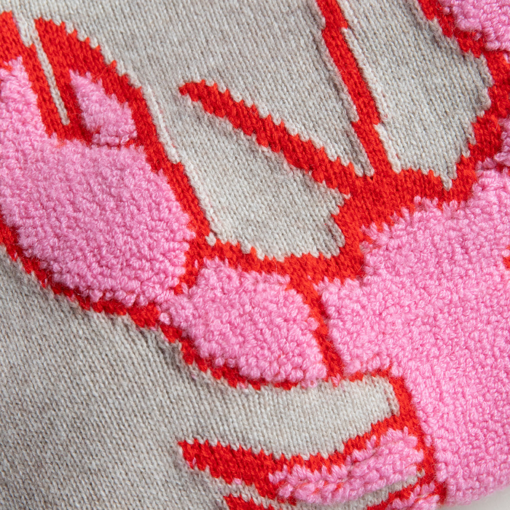 Close-up of a pink and red embroidered lobster design