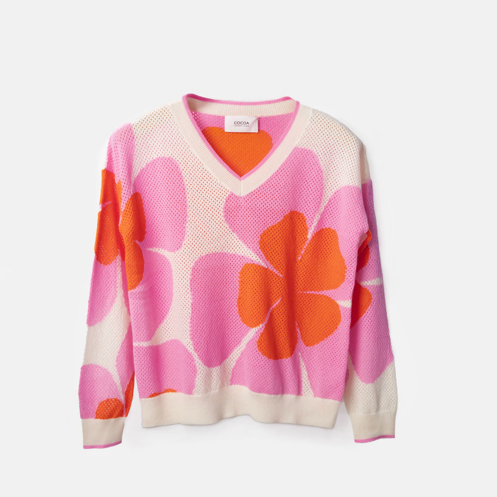 Floral patterned sweater with pink and orange flowers on a white background