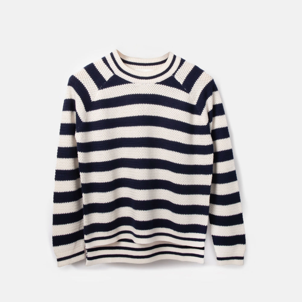 Navy and white striped sweater on a light grey background