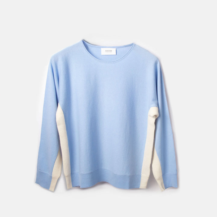 Light blue sweater with white accents on a light gray background