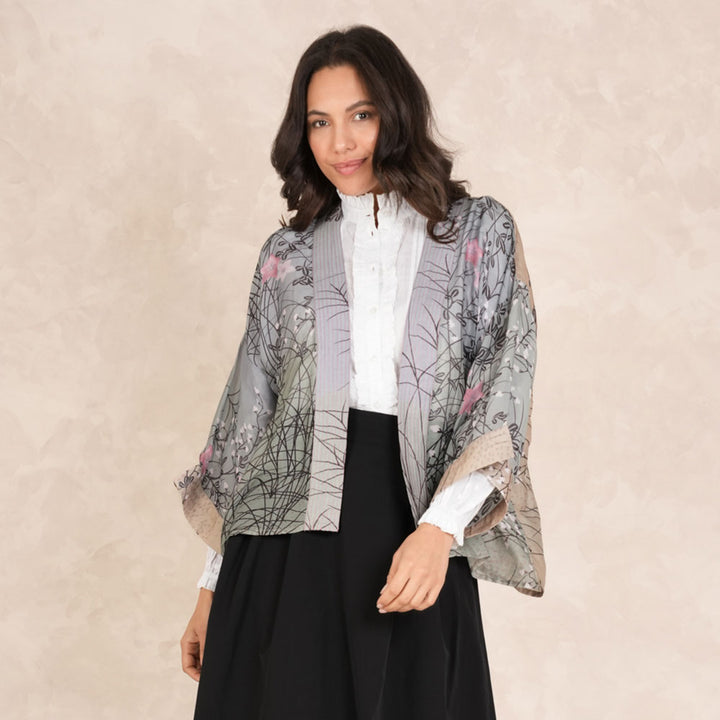 grey & green short kimono jacket with pink floral design, worn with white button through shirt and black skirt