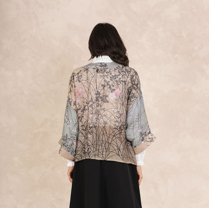 grey & green short kimono jacket with pink floral design, worn with white button through shirt and black skirt