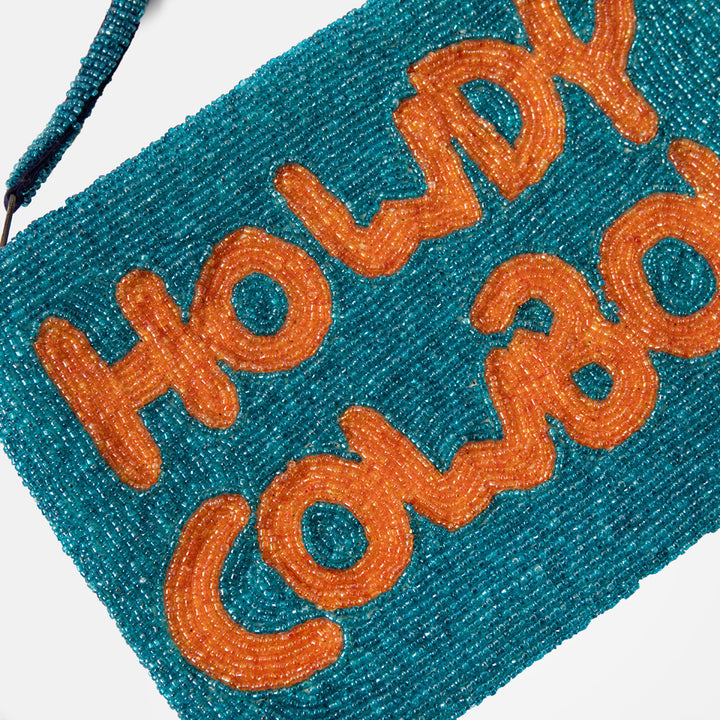 Teal clutch bag with 'Howdy Cowboy' text on a white background