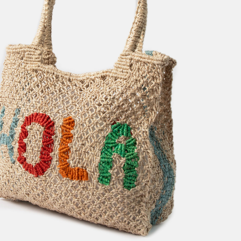 Woven jute shopper bag with 'Hola' text on a white background
