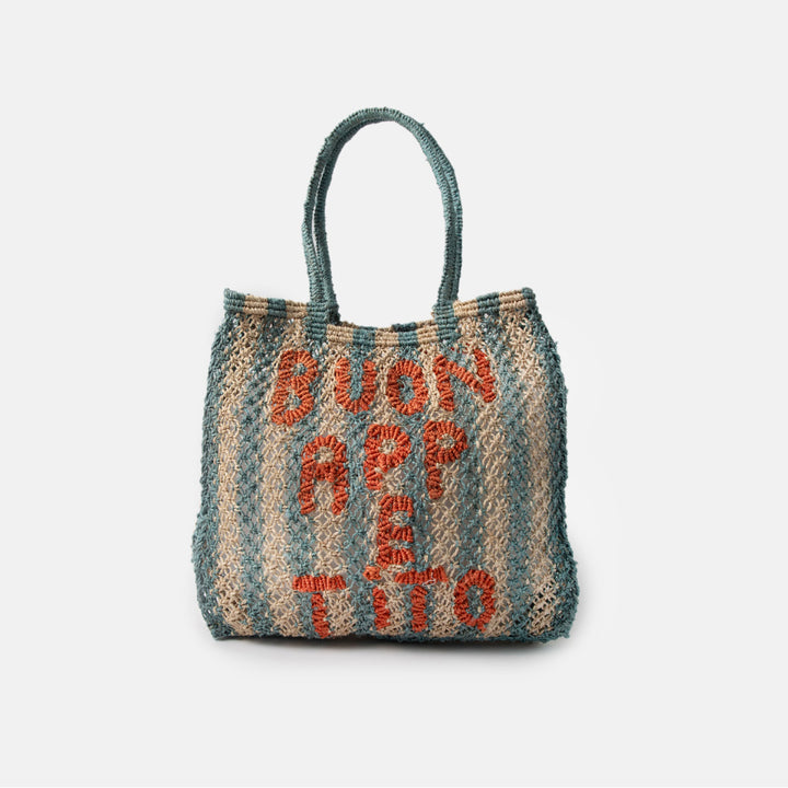 Woven jute shopper bag with blue stripes and 'Buon Appetito' text on a light gray background