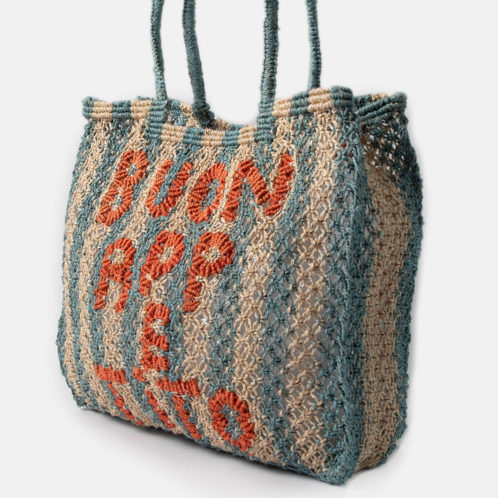 Woven jute shopper bag with blue stripes and 'Buon Appetito' text on a light gray background