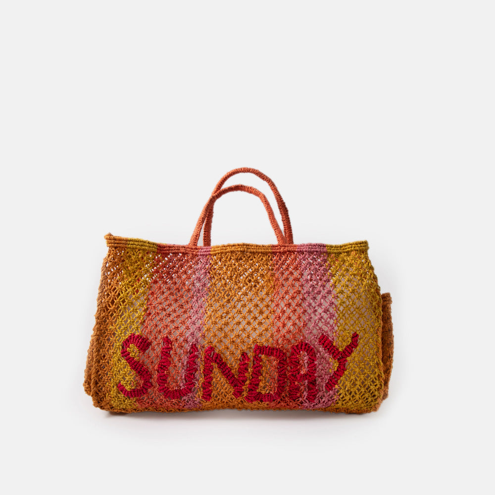 pink & yellow striped jute shopper bag with the word sunday in red, against a white background
