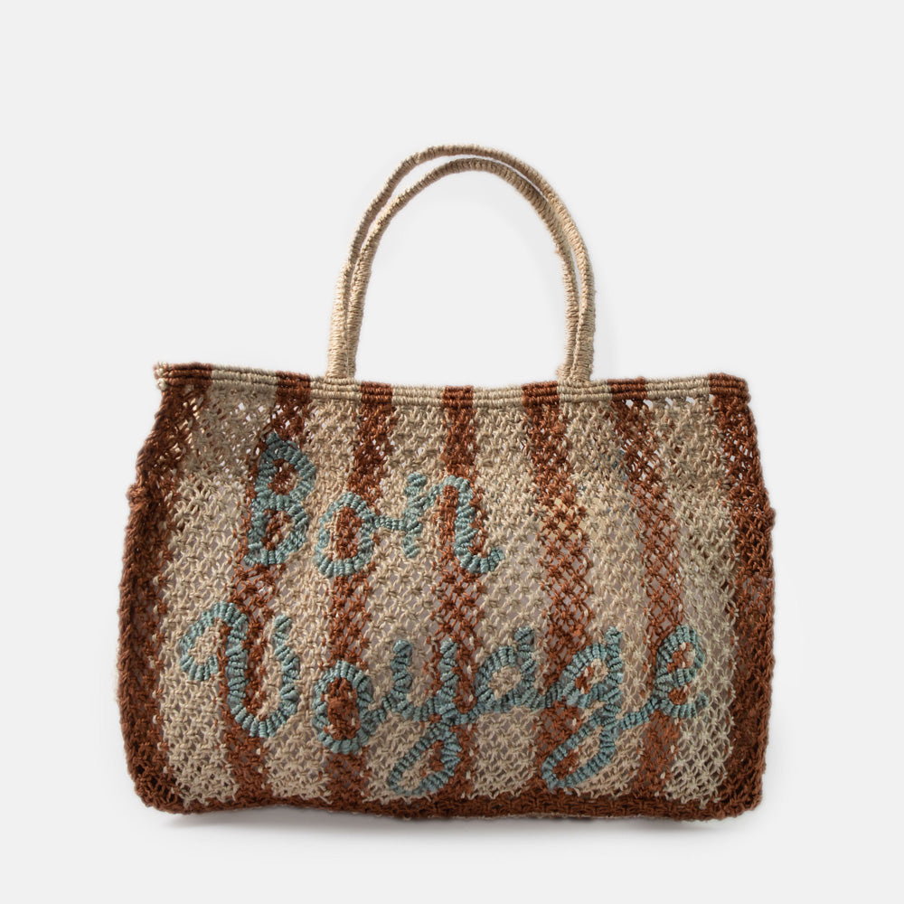 brown & natural stripe jute shopper with the words bon voyage in light blue, against a white background