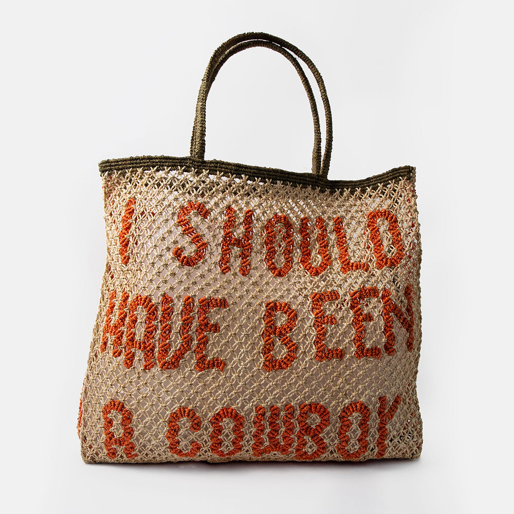 natural jute shopper bag with the text 'i should have been a cowboy' in red, against a white background
