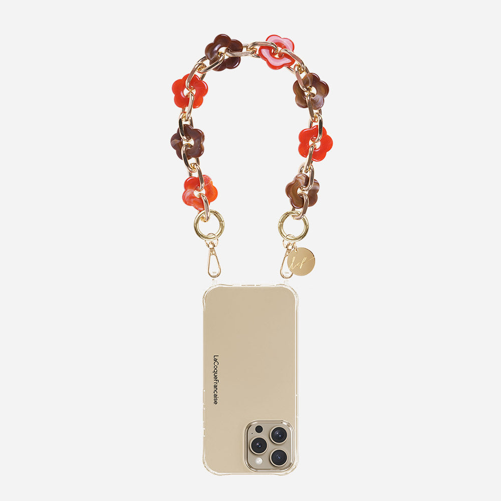 Phone case with red & brown floral chain on a beige background