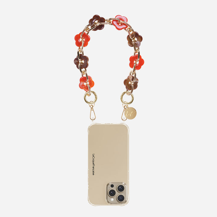 Phone case with red & brown floral chain on a beige background