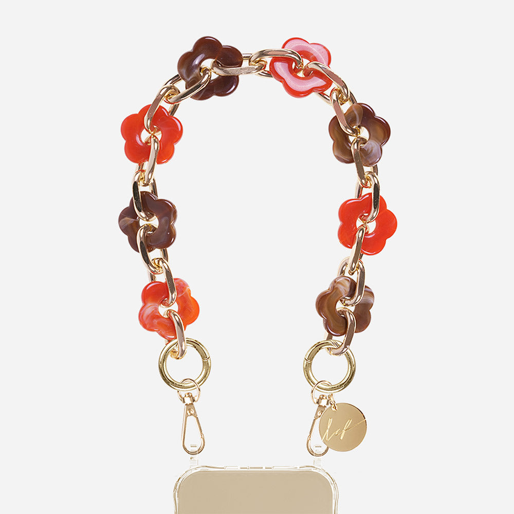 Phone case with red & brown floral chain on a beige background