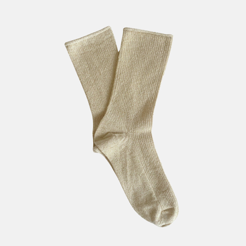 beige ribbed sparkly socks against a white background