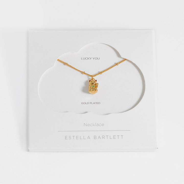 Gold necklace with a cat-shaped pendant in white packaging