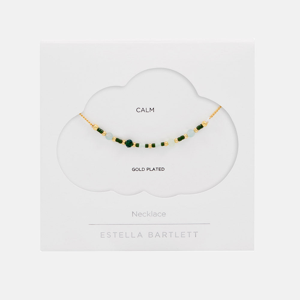 gold plated necklace with green enamel beads in white packaging