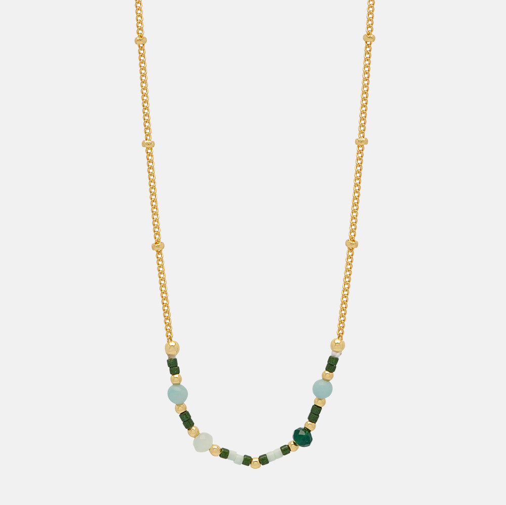 gold plated necklace with green enamel beads on a white background