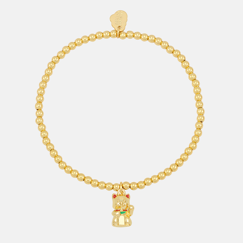 Gold beaded bracelet with a waving lucky cat charm on a white background