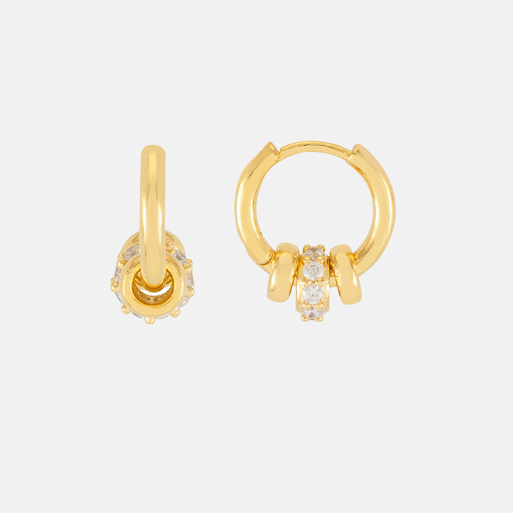 gold huggie hoop earrings with 3 gold discs, one set with cubic zirconia