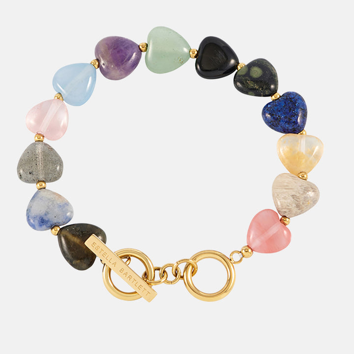 Multicolored heart-shaped stone bracelet with gold clasp on a white background