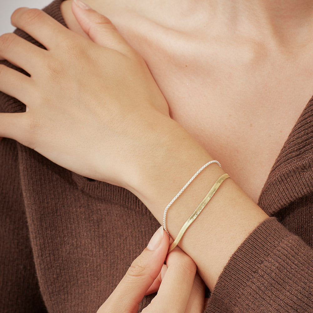 woman wearing a gold & silver double chain bracelet