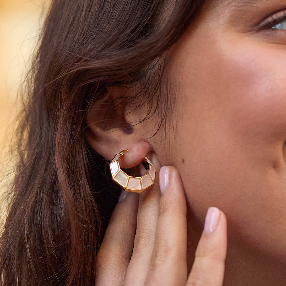 woman wearing gold & mother of pearl octagonal hinge earrings