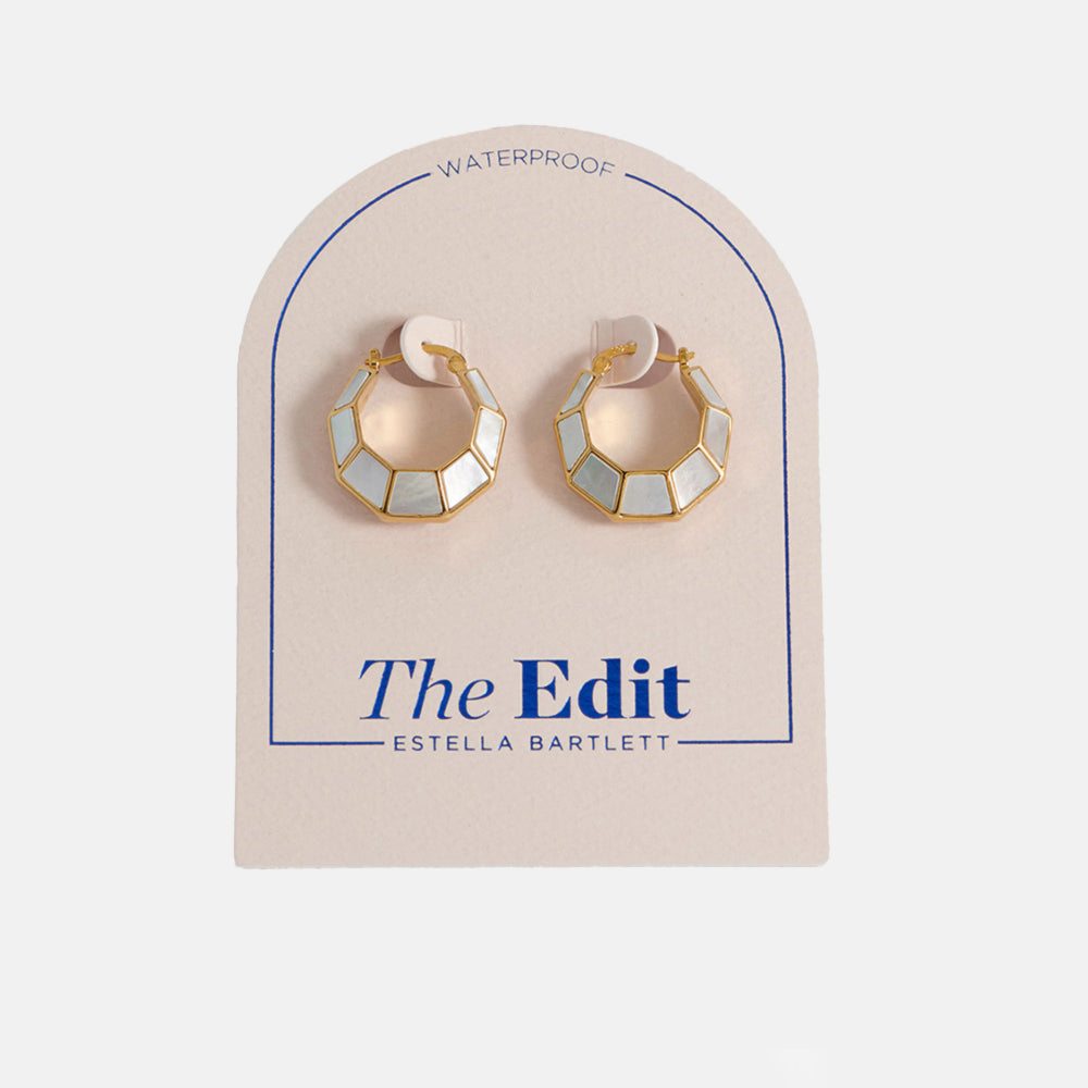 gold & mother of pearl octagonal hinge earrings in packaging on a light grey background