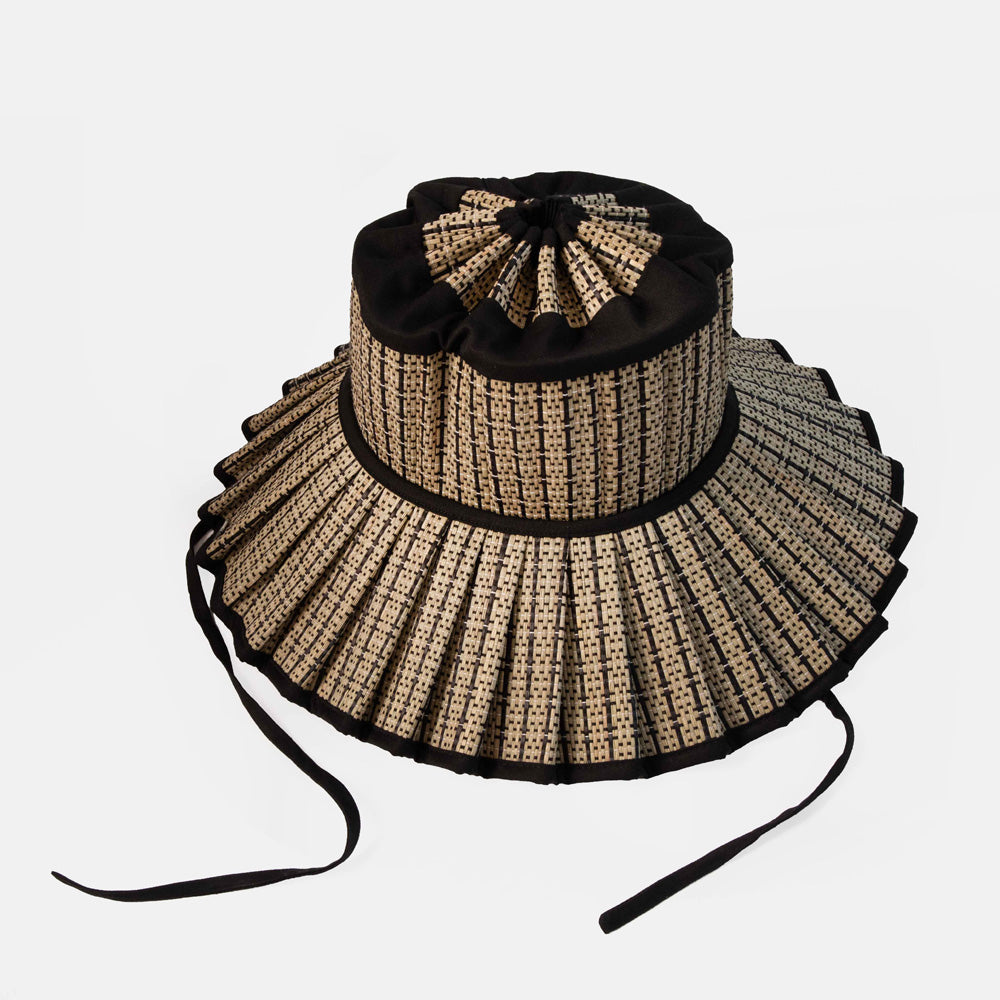 Straw hat with black band on a white background