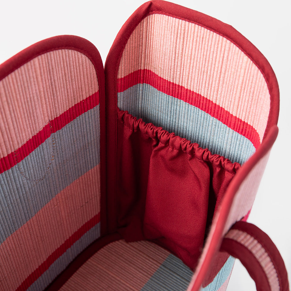 Close-up of a red and gray striped fabric with a textured pattern.