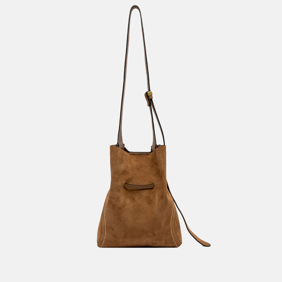 Brown suede handbag with a strap on a light grey background