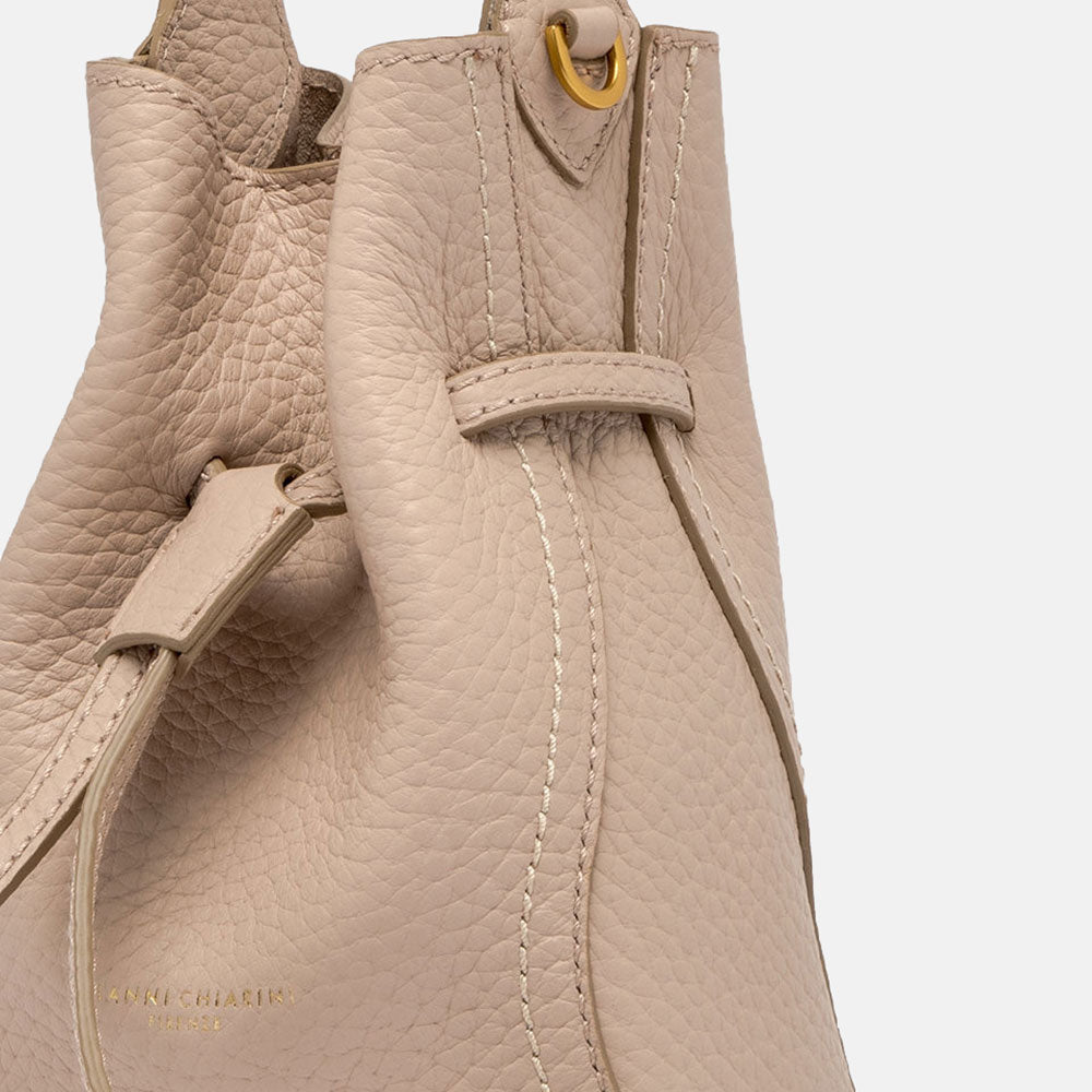 close up of light pink leather bucket bag