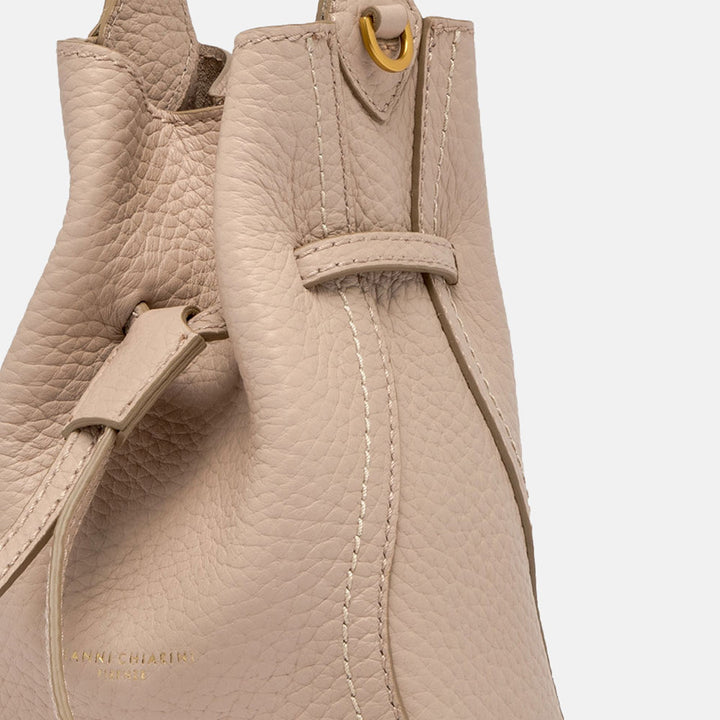 close up of light pink leather bucket bag