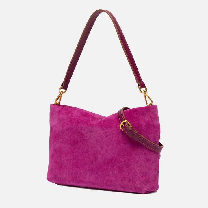 bright pink suede handbag with leather wrist and shoulder straps