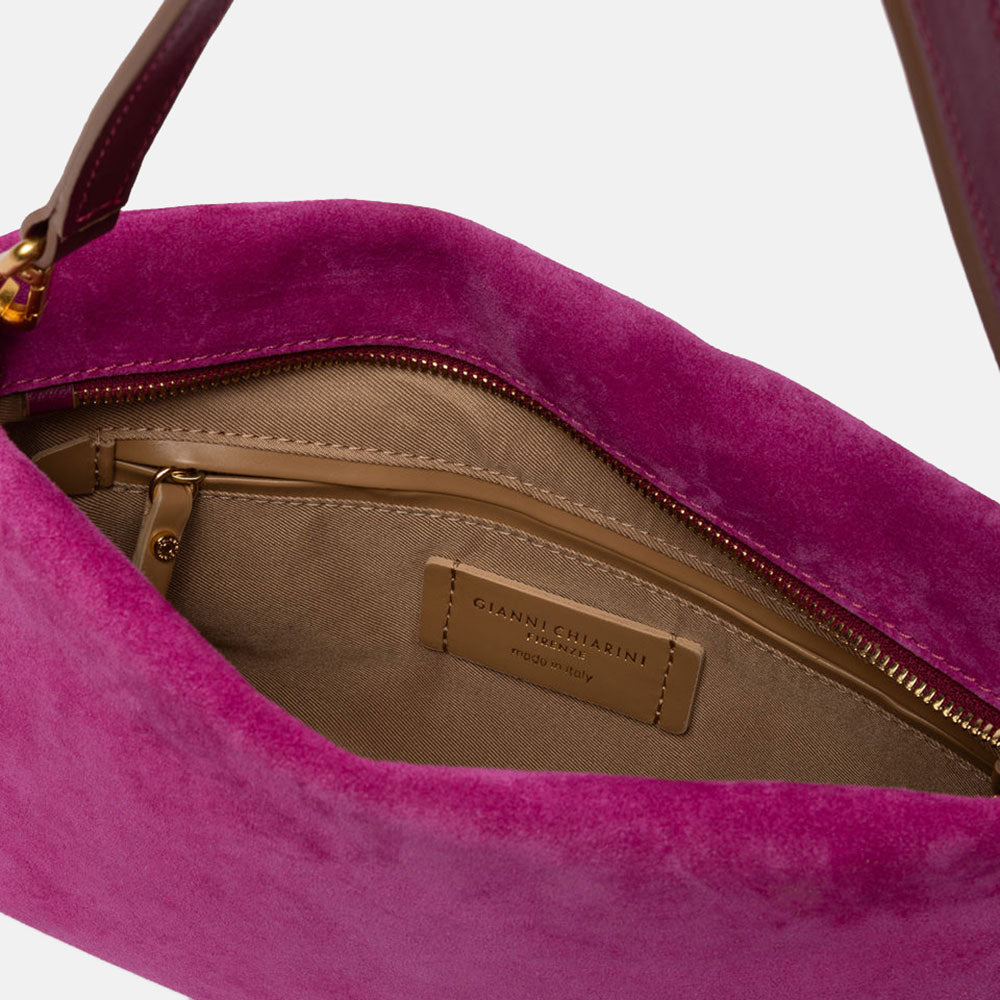 bright pink suede handbag with leather wrist and shoulder straps