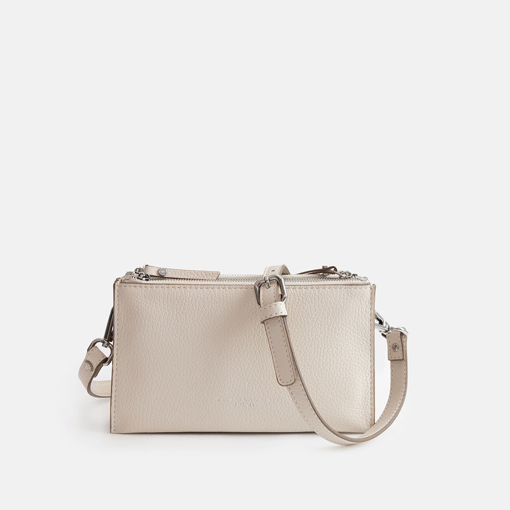 white leather envelope handbag on a light grey background