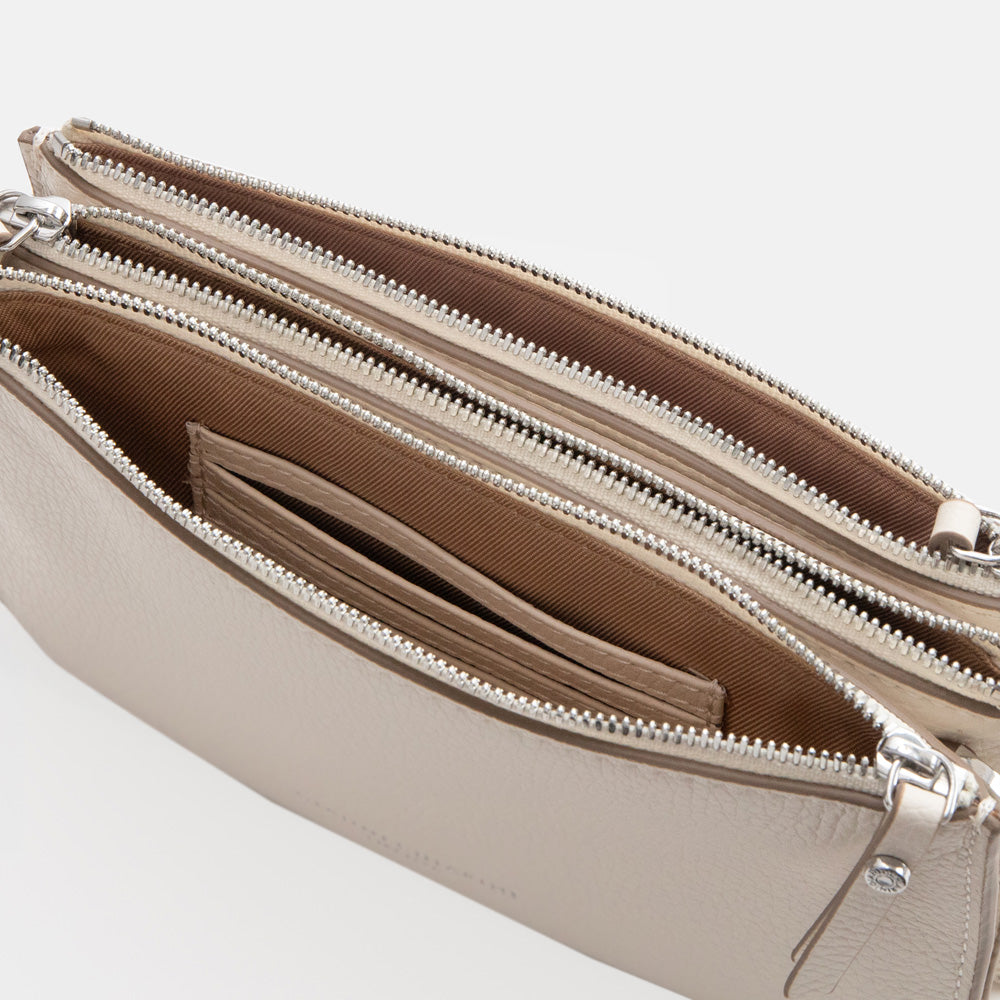 white leather envelope handbag on a light grey background