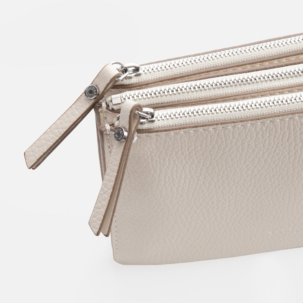 white leather envelope handbag on a light grey background