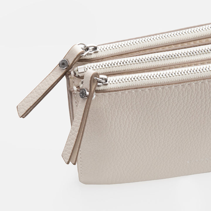 white leather envelope handbag on a light grey background