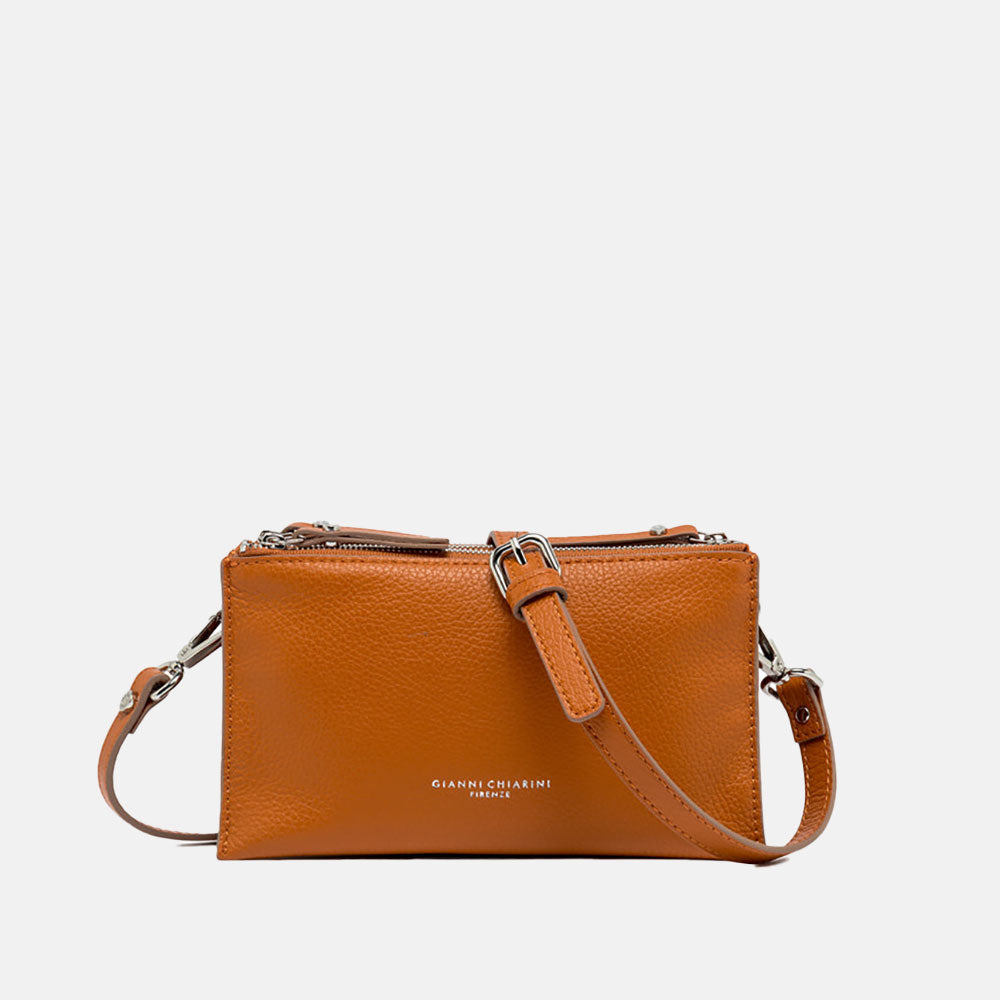 orange leather crossbody bag on a light grey background