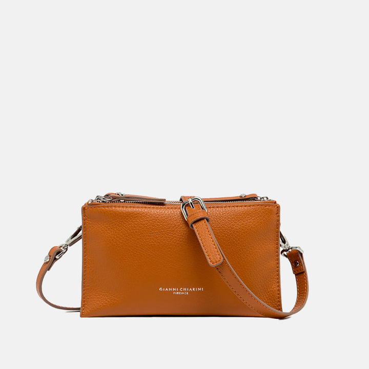 orange leather crossbody bag on a light grey background