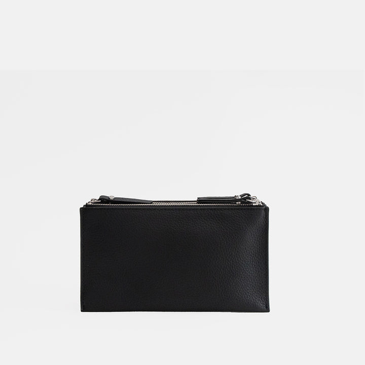 black leather envelope handbag on a light grey background