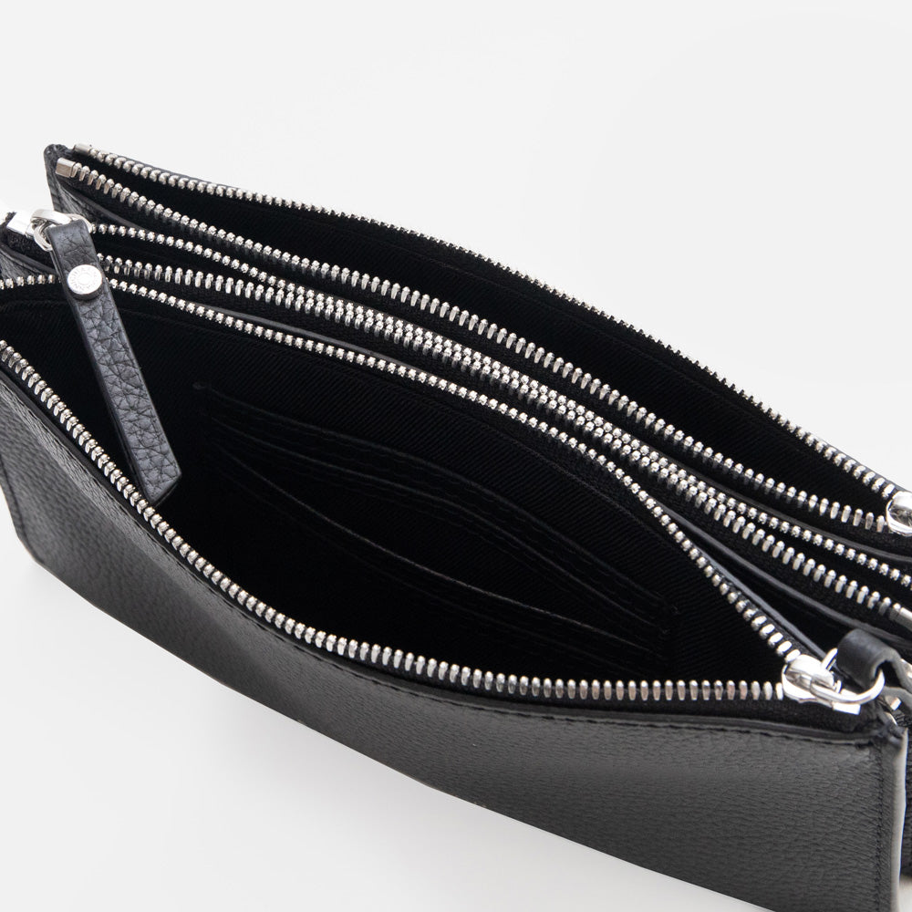 black leather envelope handbag on a light grey background